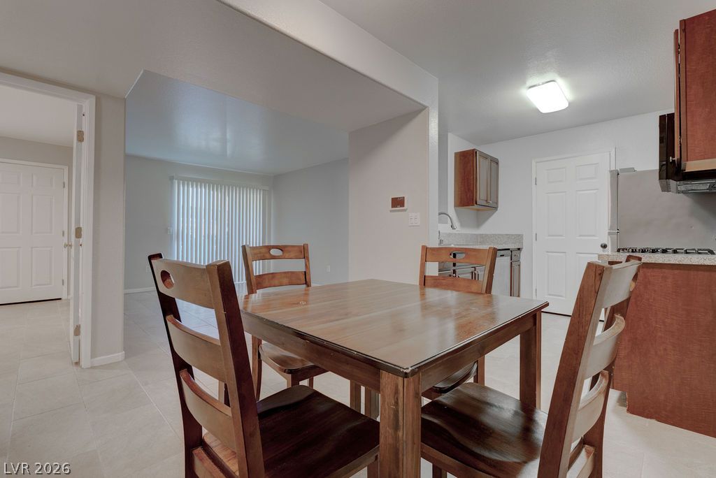 7885 West Flamingo Road, Unit 1016 Las Vegas, NV 89147 - Photo 9 of 24 Clean lines define this dining area, flowing seamlessly into the adjacent living space and kitchen.
