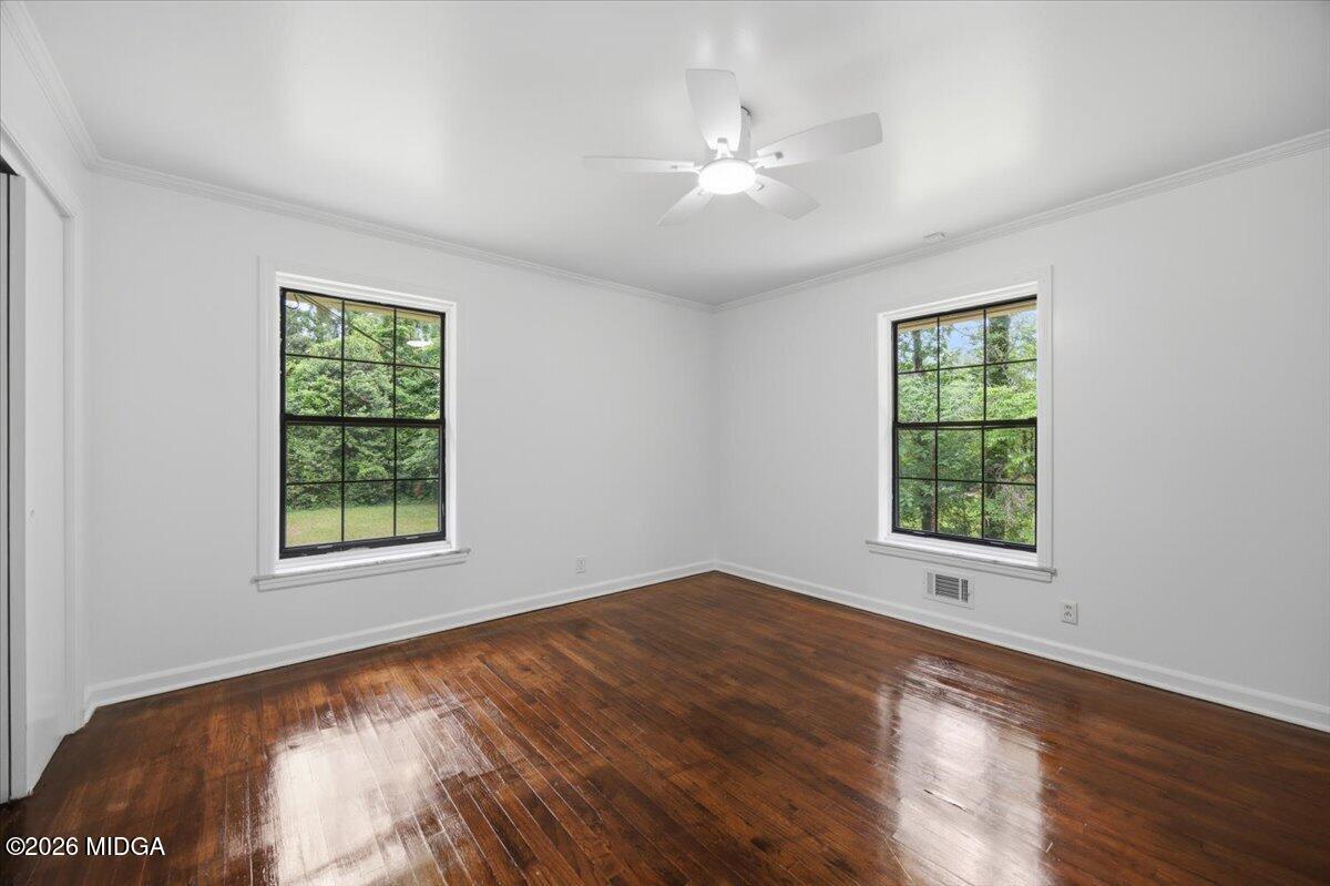 4506 Rivoli Drive Macon, GA 31210 - Photo 15 of 35 a view of an empty room with wooden floor and a window