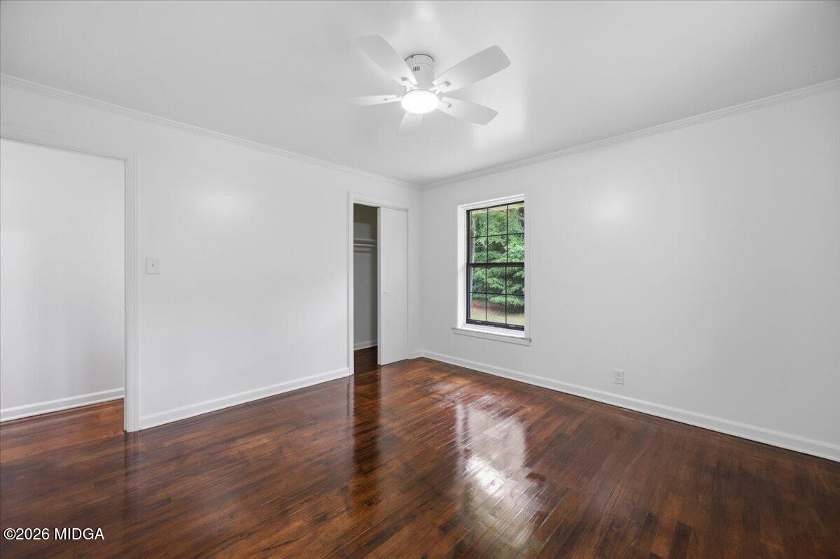 4506 Rivoli Drive Macon, GA 31210 - Photo 16 of 35 a view of an empty room with wooden floor and a window