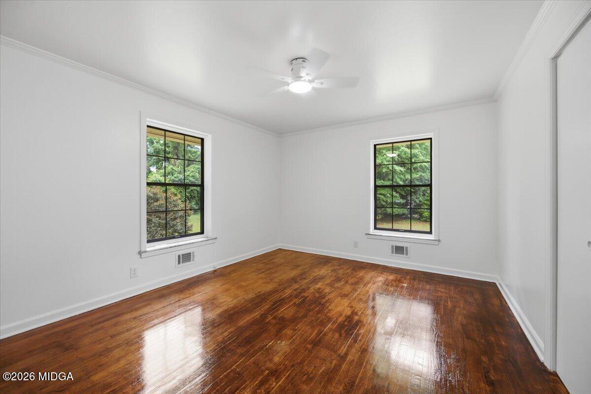 4506 Rivoli Drive Macon, GA 31210 - Photo 17 of 35 an empty room with wooden floor and windows