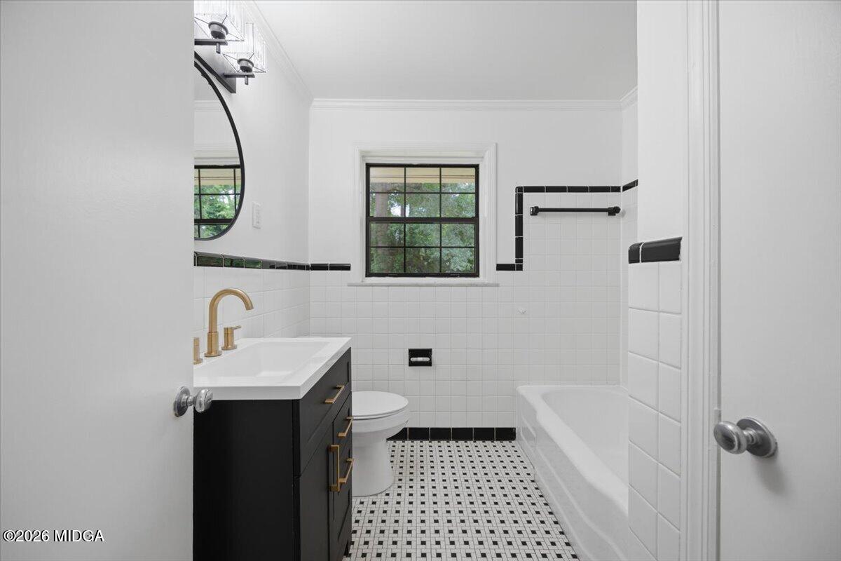 4506 Rivoli Drive Macon, GA 31210 - Photo 19 of 35 a bathroom with a sink a mirror a window and a shower