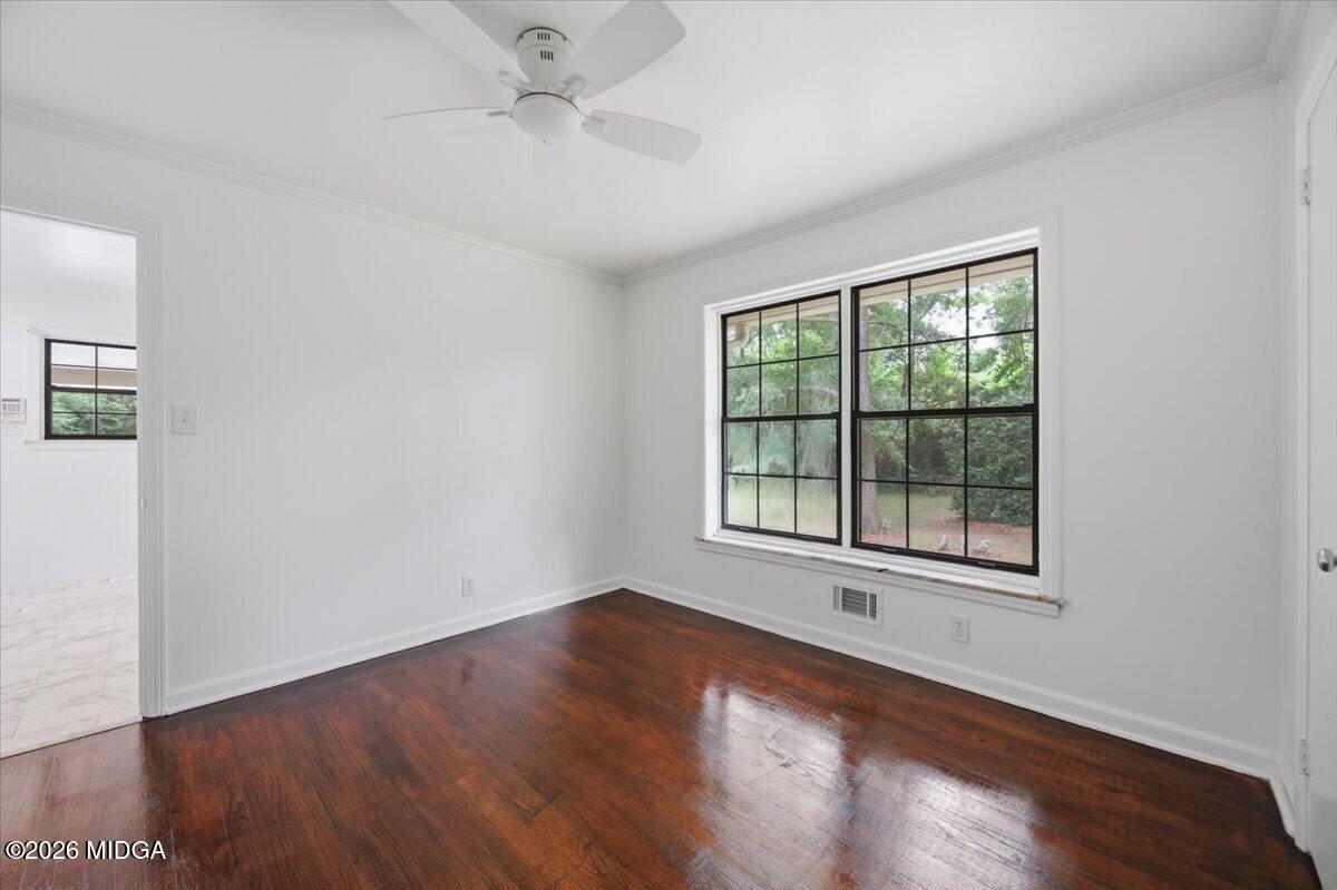 4506 Rivoli Drive Macon, GA 31210 - Photo 20 of 35 an empty room with wooden floor and windows