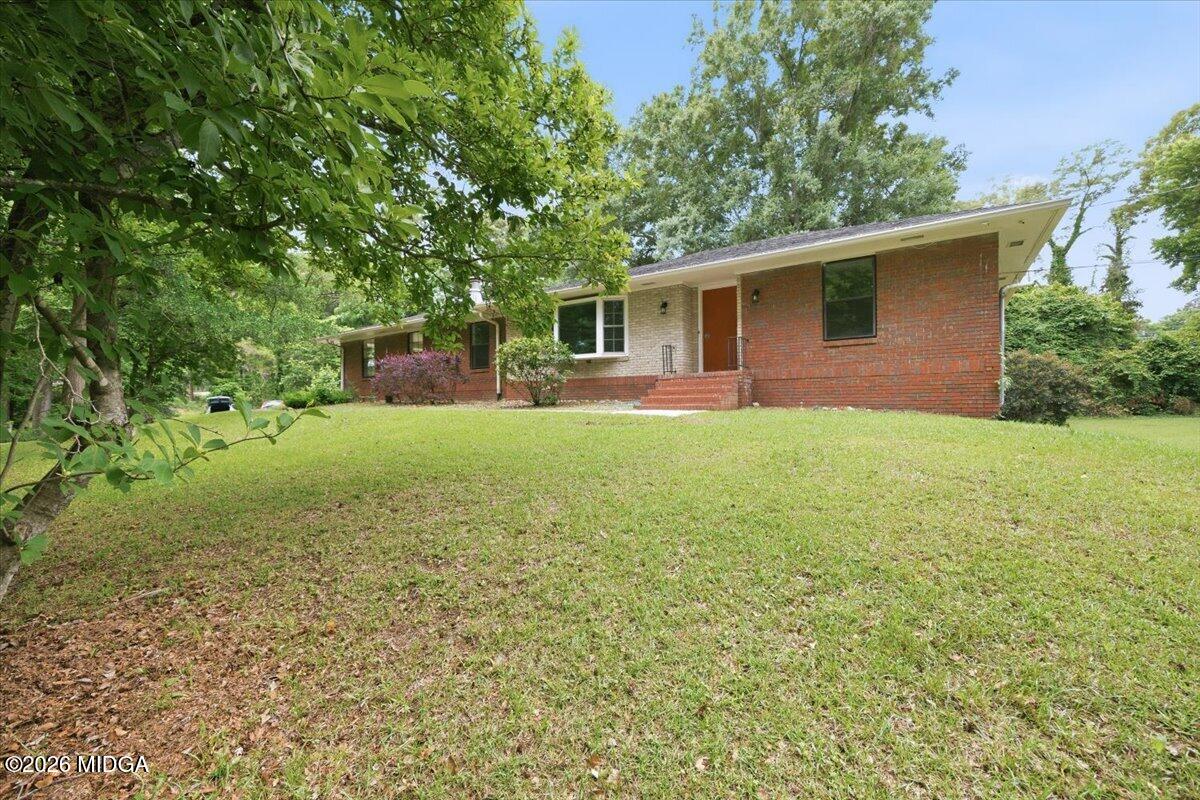 4506 Rivoli Drive Macon, GA 31210 - Photo 3 of 35 a view of a yard in front of a house with large trees