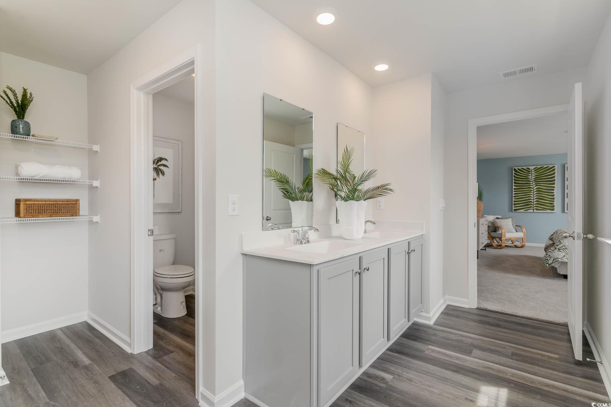 137 Homestead Way Myrtle Beach, SC 29588 - Photo 19 of 27 Ensuite bathroom with dark wood-type flooring, double vanity, and recessed lighting