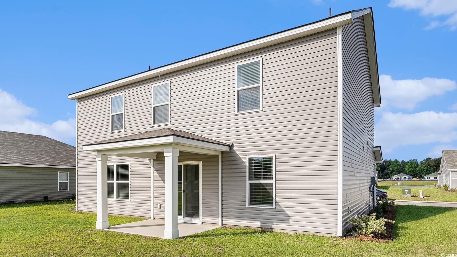 137 Homestead Way Myrtle Beach, SC 29588 - Photo 2 of 27 Back of house featuring a patio and a yard