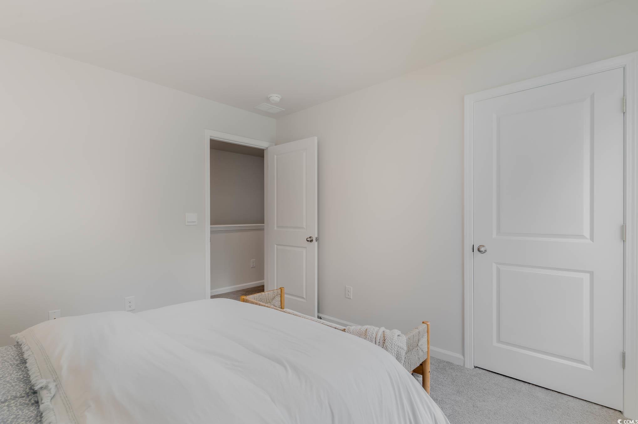 137 Homestead Way Myrtle Beach, SC 29588 - Photo 26 of 27 Bedroom with light colored carpet and baseboards