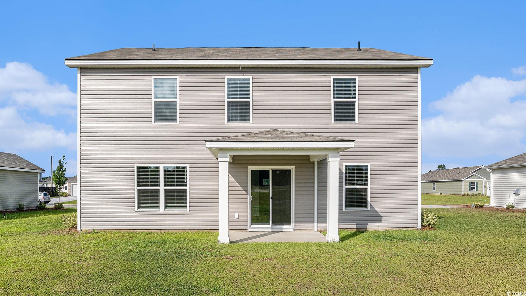 137 Homestead Way Myrtle Beach, SC 29588 - Photo 3 of 27 Back of house featuring a patio area, a lawn, and a shingled roof