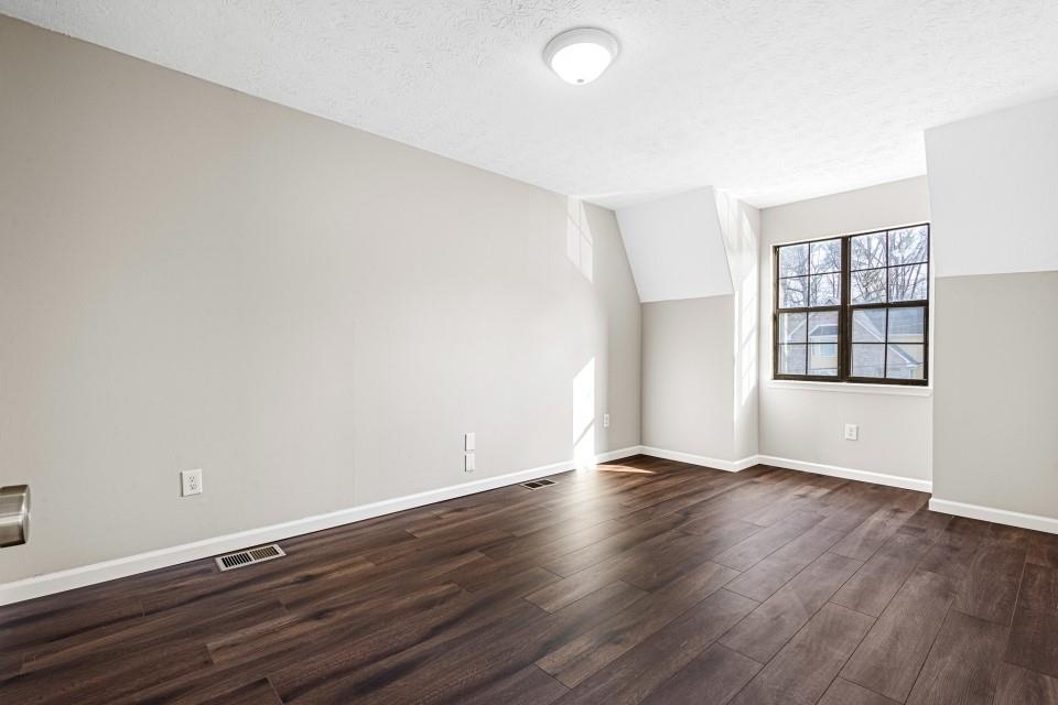 2037 Laboon Circle Atlanta, GA 30349 - Photo 15 of 18 an empty room with wooden floor and windows