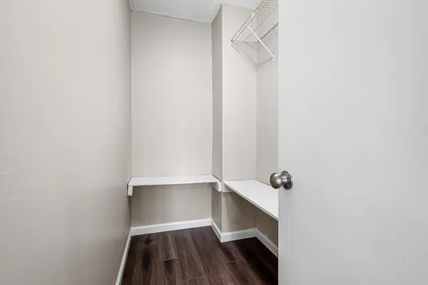 a view of walk in closet with empty racks