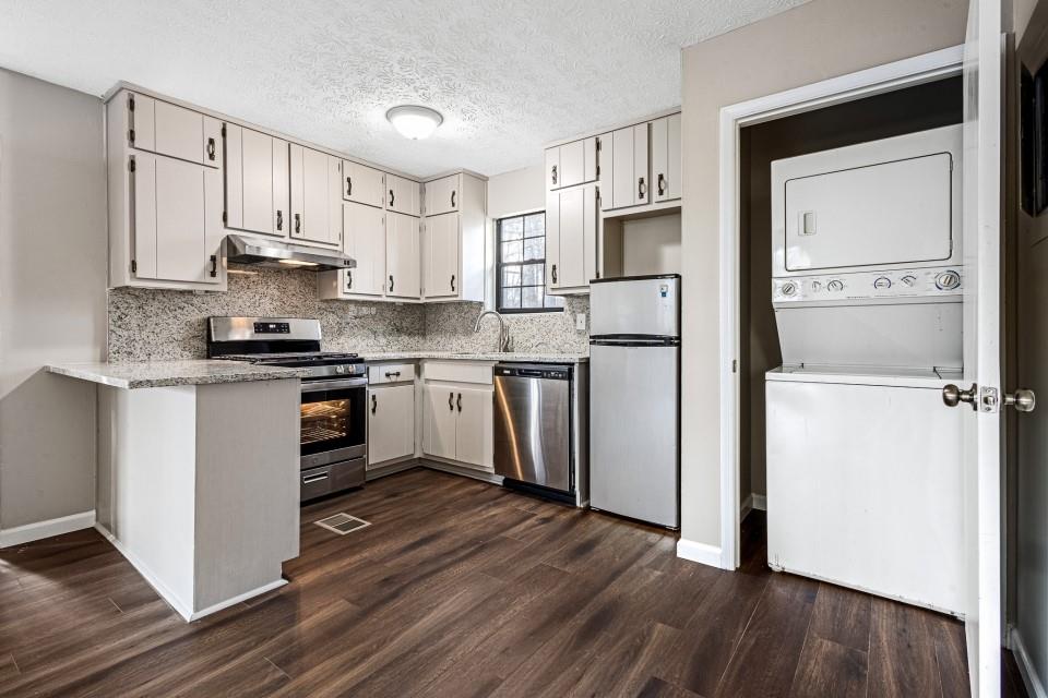 2037 Laboon Circle Atlanta, GA 30349 - Photo 18 of 18 a kitchen with granite countertop a refrigerator stove top oven and sink