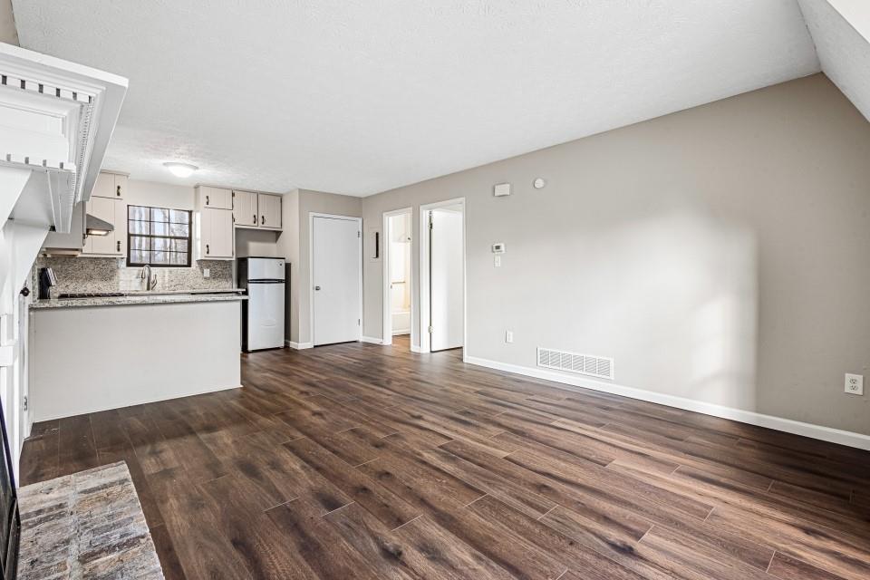 2037 Laboon Circle Atlanta, GA 30349 - Photo 3 of 18 a view of a kitchen with wooden floor and a hallway