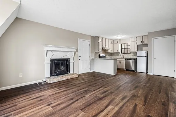 a view of a kitchen with a stove cabinets and wooden floor
