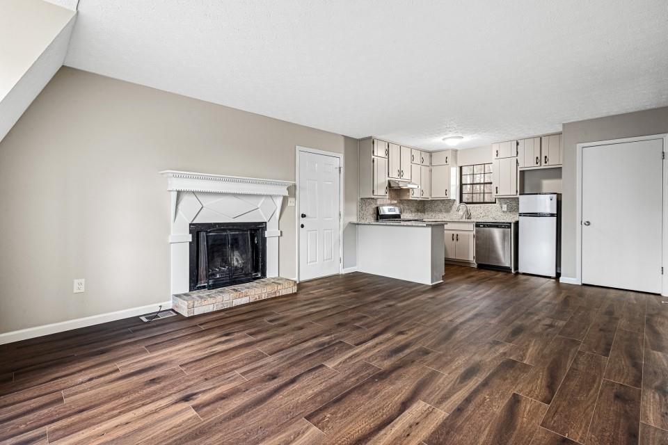 2037 Laboon Circle Atlanta, GA 30349 - Photo 4 of 18 a view of a kitchen with a stove cabinets and wooden floor