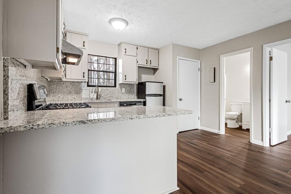 2037 Laboon Circle Atlanta, GA 30349 - Photo 6 of 18 a large bedroom with a bed and a view of living room