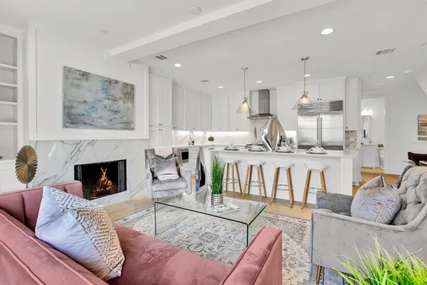 a living room with furniture a fireplace and a table