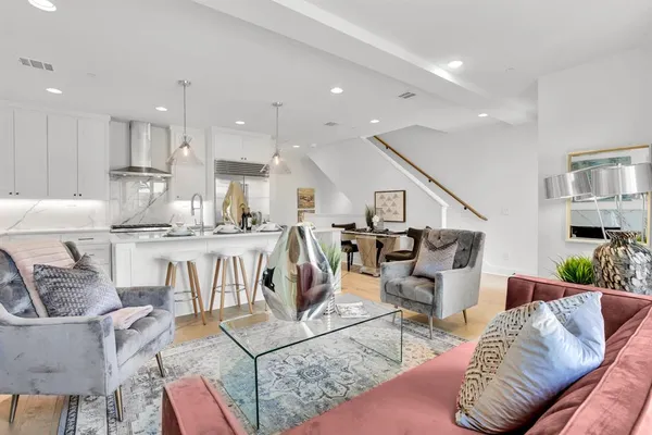 a living room with furniture a fireplace and a table