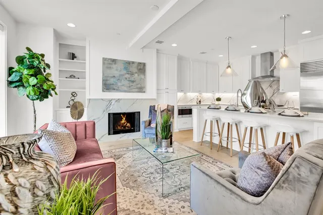 a living room with lots of furniture and kitchen view