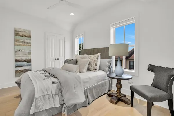 a balcony view with a potted plant and outdoor seating