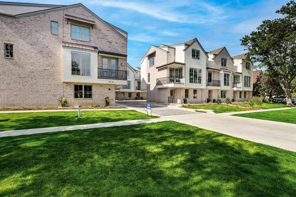 a front view of building with yard and green space