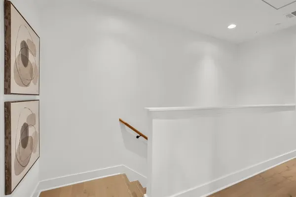 a very nice looking dining room with wooden floor and dining table