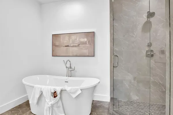 a bathroom with a tub and shower