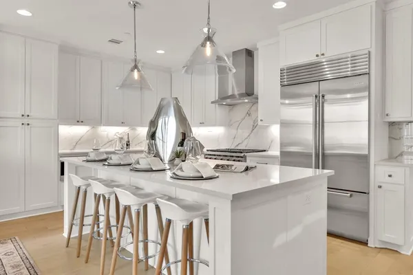 a kitchen with kitchen island granite countertop a sink a center island stainless steel appliances and cabinets