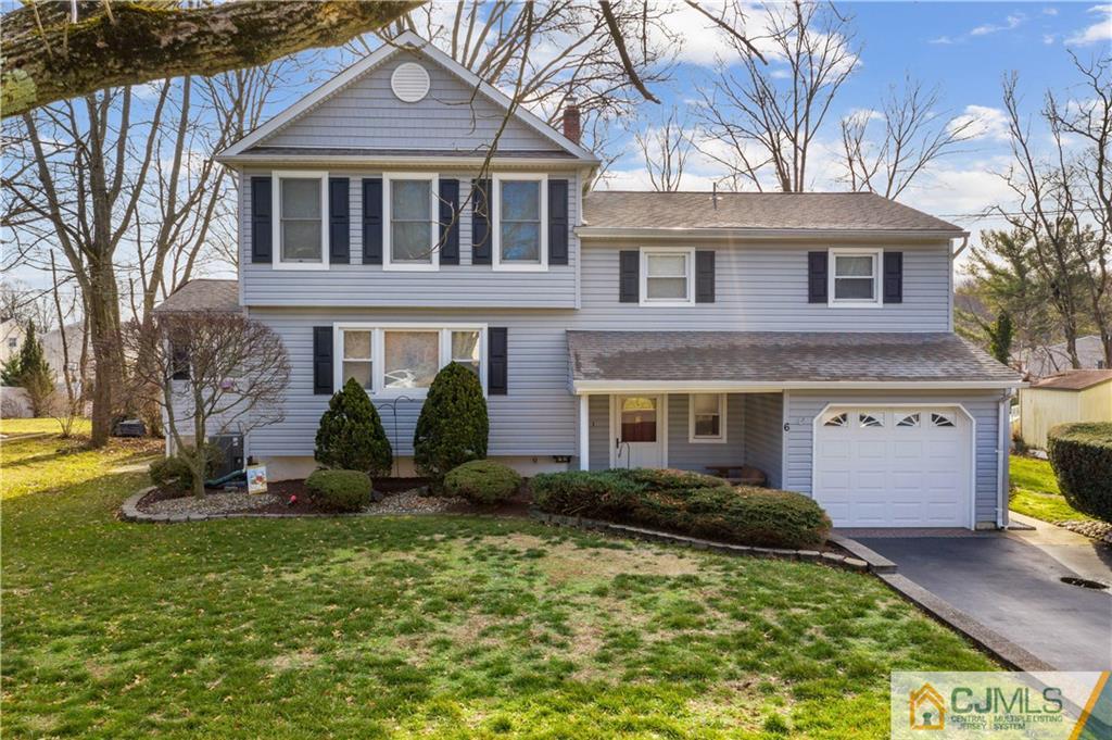 6 Albemarle Road East Brunswick, NJ 08816 - Photo 1 of 30 a front view of a house with a yard and fountain