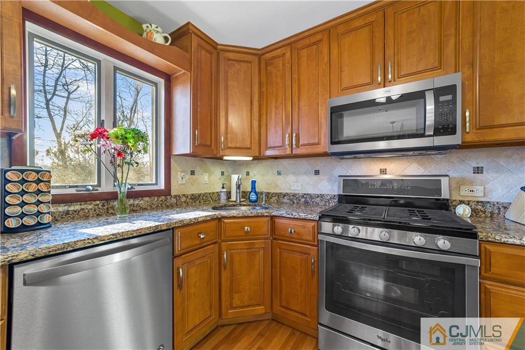 6 Albemarle Road East Brunswick, NJ 08816 - Photo 14 of 30 a kitchen with stainless steel appliances granite countertop a stove a sink and a microwave