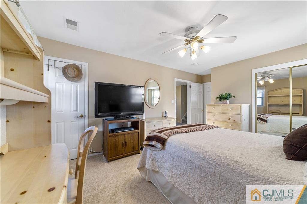 6 Albemarle Road East Brunswick, NJ 08816 - Photo 16 of 30 a bedroom with a bed and a flat screen tv