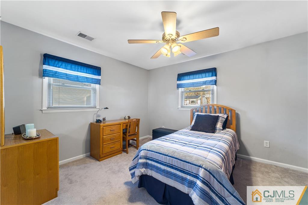 6 Albemarle Road East Brunswick, NJ 08816 - Photo 17 of 30 a bedroom with a bed and a chandelier