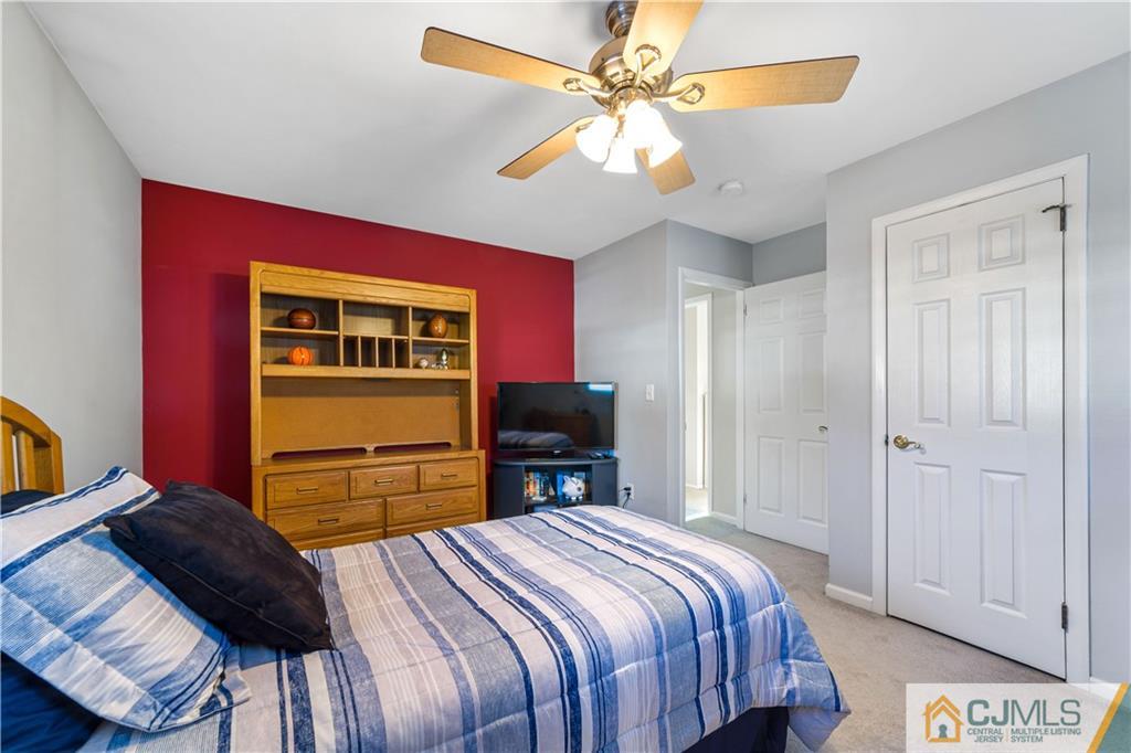 6 Albemarle Road East Brunswick, NJ 08816 - Photo 18 of 30 a bedroom with a bed and a chandelier