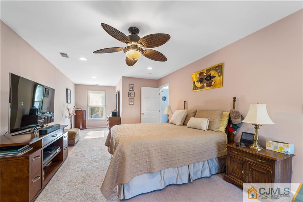 6 Albemarle Road East Brunswick, NJ 08816 - Photo 24 of 30 a bedroom with a bed and a flat screen tv