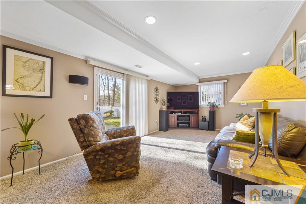 6 Albemarle Road East Brunswick, NJ 08816 - Photo 3 of 30 a living room with furniture and a flat screen tv