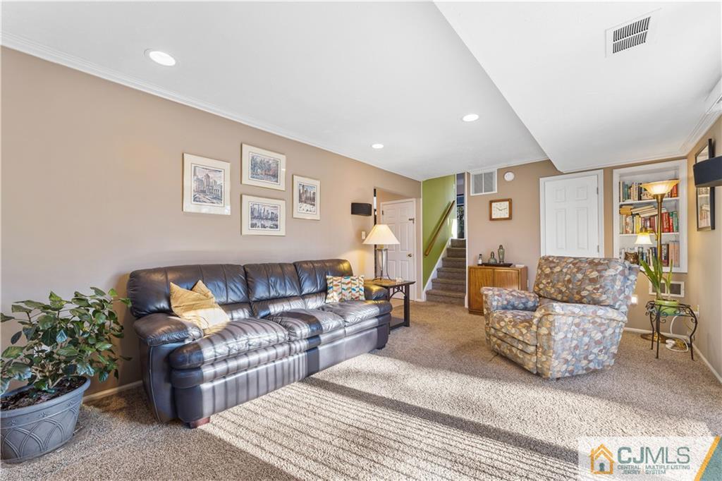 6 Albemarle Road East Brunswick, NJ 08816 - Photo 4 of 30 a living room with furniture and flowers