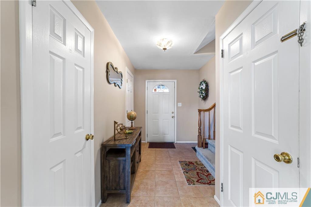 6 Albemarle Road East Brunswick, NJ 08816 - Photo 5 of 30 a hallway with a large cabinets and wooden floor