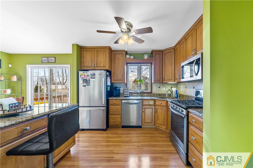 6 Albemarle Road East Brunswick, NJ 08816 - Photo 10 of 30 a kitchen with stainless steel appliances granite countertop a refrigerator a stove top oven a sink and dishwasher