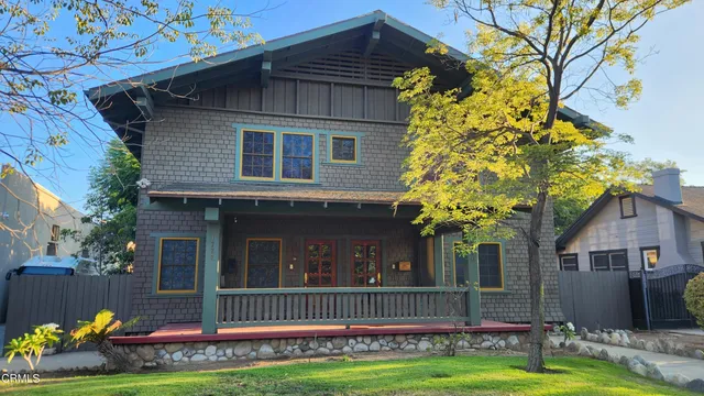 a front view of a house with a garden and plants