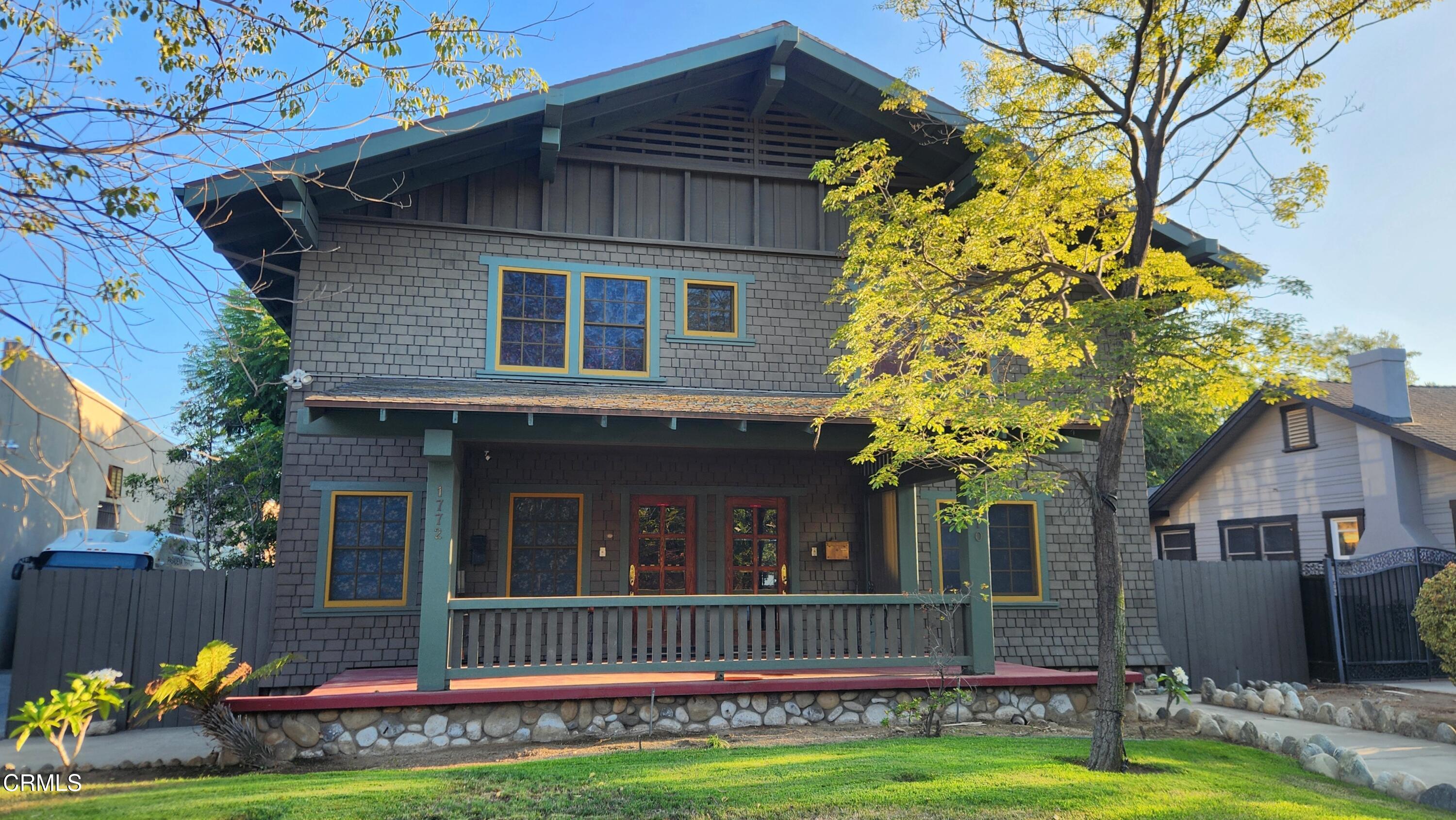 a front view of a house with a garden and plants