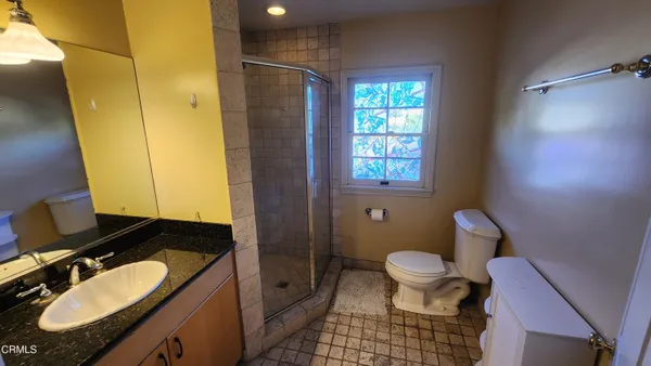 a bedroom with a bed and a view of bathroom