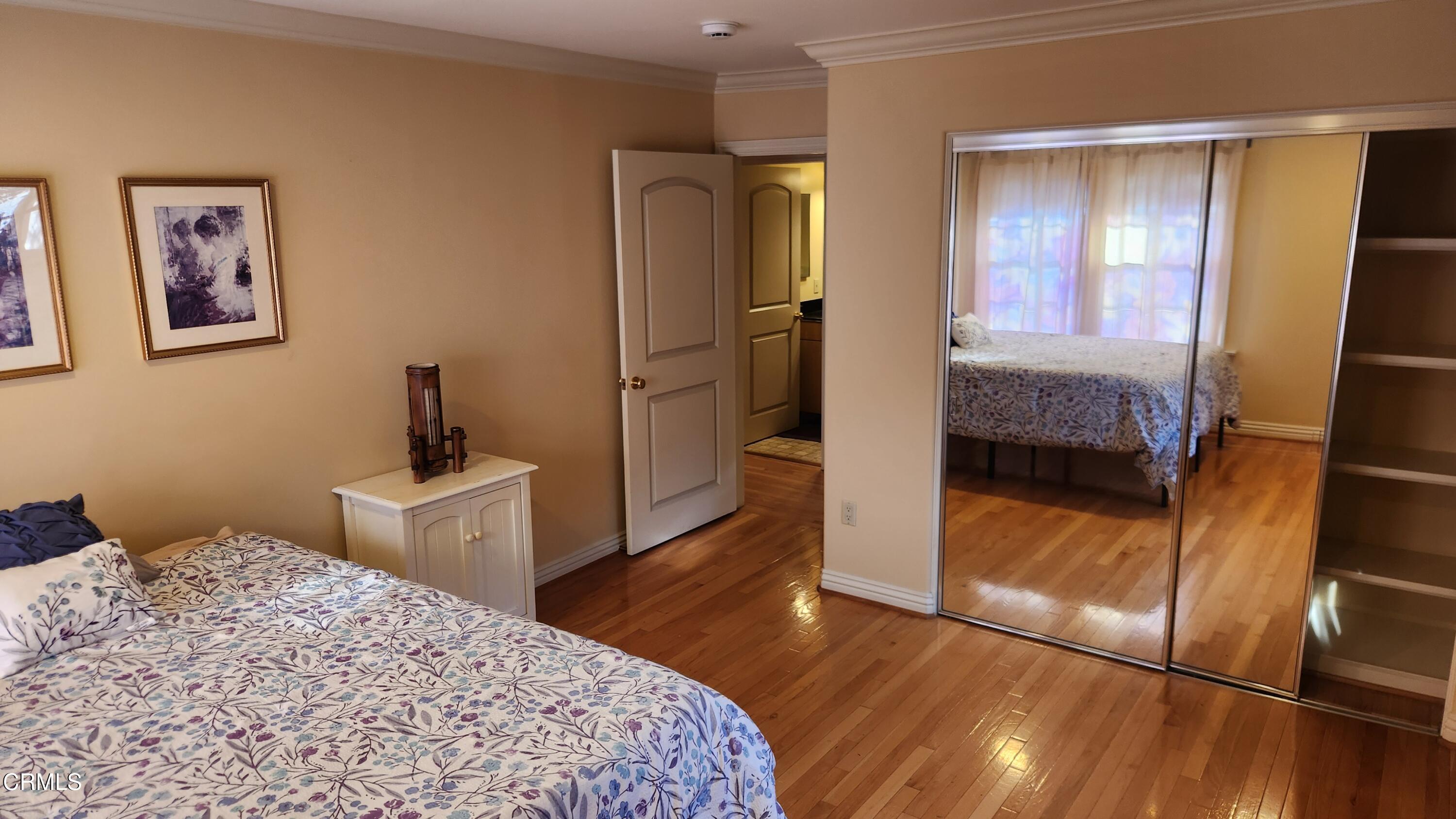 1772 Corson Street Pasadena, CA 91106 - Photo 15 of 25 a bedroom with a bed and a refrigerator