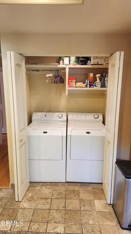 a view of a backyard with a table and chairs and a fire pit