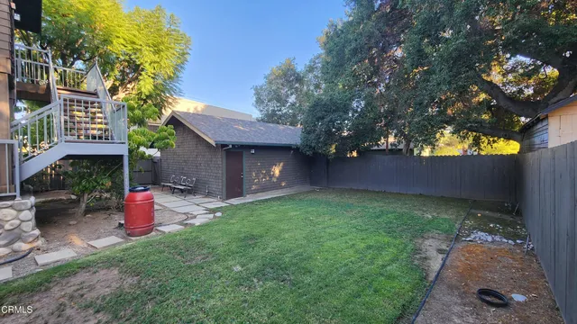 a view of backyard with outdoor seating