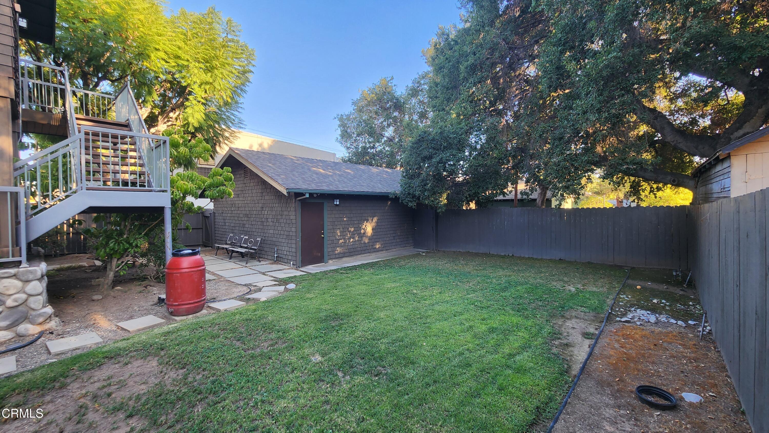 1772 Corson Street Pasadena, CA 91106 - Photo 22 of 25 a view of a backyard with a fountain plants and large tree