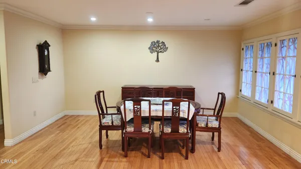 a view of a dining room with furniture and wooden floor
