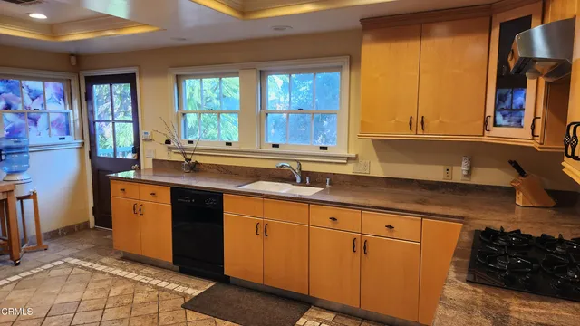 a kitchen with sink cabinets and window