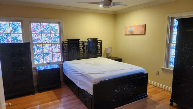 a bed sitting in a bedroom next to a window