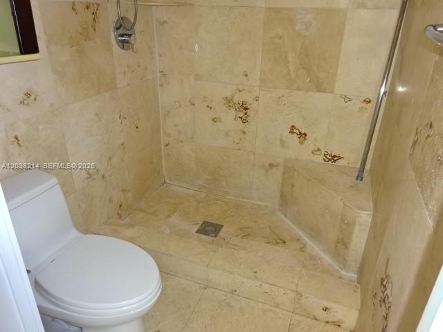 9727 Hammocks Boulevard, Unit 101D Miami, FL 33196 - Photo 11 of 12 a bathroom with a toilet and shower