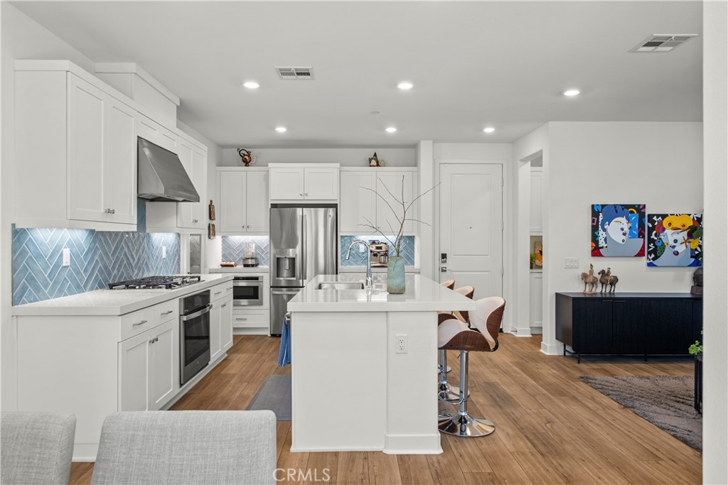 1663 Rosewell Road West Covina, CA 91791 - Photo 6 of 45 a large kitchen with a large counter top appliances and cabinets