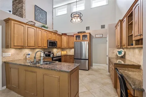 a kitchen with stainless steel appliances granite countertop a sink and cabinets