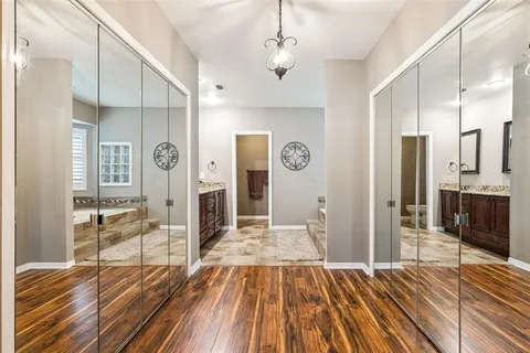 a bedroom with a bed and a flat tv screen on dresser
